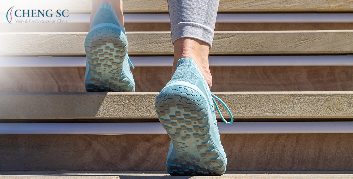 Person climbing stairs in supportive shoes for vein health