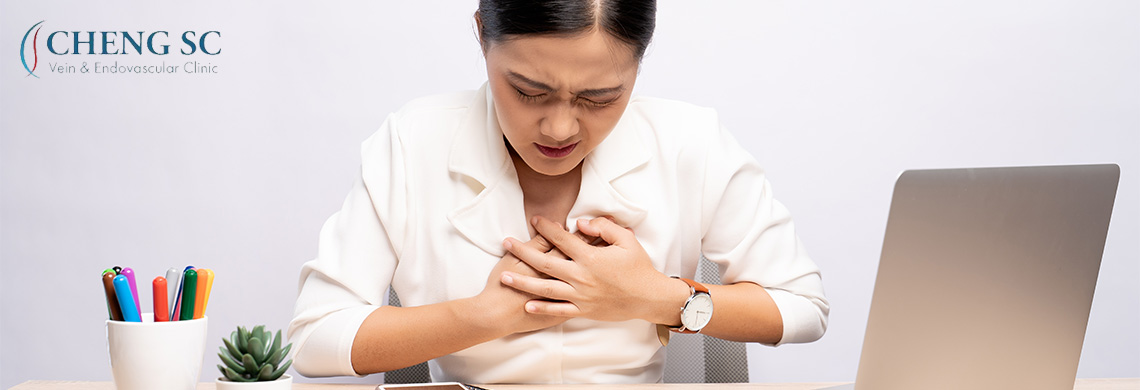 woman in pain clutching her chest